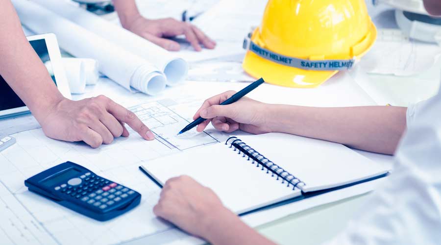 Contractors around construction plans